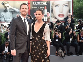 Michael Fassbender and Swedish actress Alicia Vikander pose on the red carpet before the premiere of the movie 'The Light Between Oceans' presented in competition at the 73rd Venice Film Festival on September 1, 2016 at Venice Lido. / AFP / TIZIANA FABI (Photo credit should read TIZIANA FABI/AFP/Getty Images)