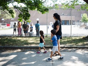 Serina Manek is seen in her Leslieville neighbourhood in Toronto with her two children Zane (5) and Mia (3) Partridge on Wednesday, August 30, 2017. Manek says that the increase in condo development has not only made student placement in local schools more difficult, but traffic through local streets and alleyways have also increased. (The Canadian Press/Christopher Katsarov)