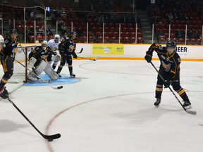 Owen Sound Attack centre Nick Suzuki, foreground left, was met by his younger brother, Ryan Suzuki, far right, a centre with the Barrie Colts, during an Ontario Hockey League exhibition game this weekend. It was the London natives? first time ever playing each other. Denis Langlois/The Owen Sound Sun Times/Postmedia Network