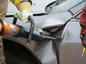 A participant uses the Jaws of Life to pry open a car door at the Town’s Public Works Yard on Sept. 2 (Peter Shokeir | Whitecourt Star).