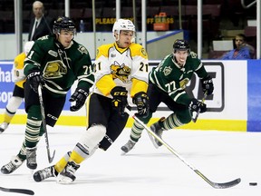 Sarnia Sting's Adam Ruzicka (21) falls after being hooked by London Knights' Dalton Duhart (71) as Knights' Tim Fallowfield (77) watches in the first period of an OHL exhibition game at Progressive Auto Sales Arena in Sarnia, Ont., on Saturday, Sept. 2, 2017. (MARK MALONE/Postmedia Network)