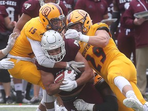 Ottawa Gee-Gees’ Nick Dagher rushes against the Queen's Golden Gaels during first-half action in an Ontario University Athletics football game in Ottawa on Monday, (Tony Caldwell, Postmedia Network)