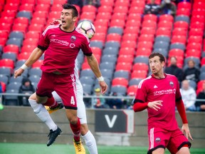 Fury FC’s Ramon Martin Del Campo goes up for the ball while getting tangled with Saint Louis FC’s Christian Volesky on Sunday. (ASHLEY FRASER/Postmedia Network)
