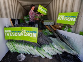 Mayor Don Iveson unpacks a storage container filled with election signs, as he prepares for the upcoming election, in Edmonton Monday Sept. 4, 2017. (DAVID BLOOM)