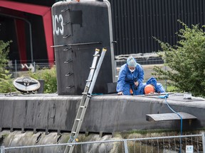 This is a Monday Aug. 14, 2017 file photo of police technicians on board the home-made submarine UC3 Nautilus on a pier in Copenhagen harbour, Denmark to conduct forensic probes in connection with a missing journalist investigation. Danish police on Tuesday Aug. 29, 2017 scanned the home-made submarine where Swedish journalist Kim Wall was last seen alive, saying they are looking for any possible concealed cavities. (Mogens Flindt/Ritzau Foto, File via AP)