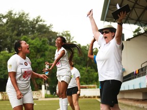 Londoner Linda Whitehead celebrates with a couple female soccer players in Goa, India. Whitehead recently participated in a combination soccer/women’s rights festival organized by German NGO Discover Football. (Alexa Vachon/Special to Postmedia News/Discover Football)