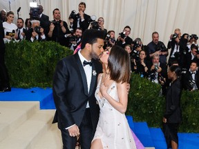 The Weeknd and Selena Gomez kiss on the red carpet Metropolitan Costume Institute Benefit Gala, May 2, 2017. (WENN.COM)
