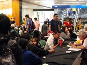 Fire evacuees register with the Canadian Red Cross at the RBC Convention Centre in Winnipeg on Friday, Sept. 1, 2017. The RBC Convention Centre is one of several locations being used to house evacuees from several northern Manitoba communities forced to flee from forest fires. The Red Cross opened a second shelter in Winnipeg on Friday morning at Winnipeg North Soccer Complex on Leila Avenue.  
SCOTT BILLECK/Winnipeg Sun/Postmedia Network