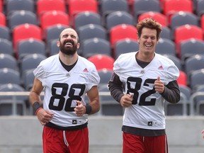 Redblacks receivers Brad Sinopoli (left) and Greg Ellingson share a laugh during practice at TD Place on Tuesday.. Ellingson needs 967 yards in the final seven games to reach 2,000 yards. (Tony Caldwell/Ottawa Sun)