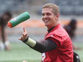 Ottawa Redblacks’ Trevor Harris tosses a water bottle during practice at TD Place on Tuesday. (Tony Caldwell/Ottawa Sun)