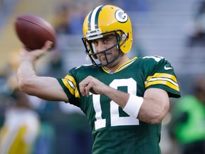 In this Aug. 31, 2017, file photo, Green Bay Packers' Aaron Rodgers warms up before a preseason NFL football game against the Los Angeles Rams, in Green Bay, Wis. (AP Photo/Jeffrey Phelps, File)
