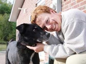 Marcia Ranger gets kisses from her dog Ebony at their south-end home in Sudbury on Tuesday. Ranger, Ebony and a friend had an encounter with a bear on Monday around 6 p.m., with both women being injured. The wound on Ranger's face required 20 stitches