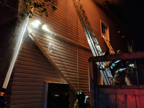 Ottawa firefighters work on a two-alarm blaze on Lajoie Street in Vanier early Sept. 6, 2017.