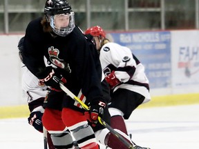 Sarnia Legionnaires' Joey Zappa protects the puck from Chatham Maroons' Thomas Michaud during the first period of a GOJHL exhibition game at Chatham Memorial Arena on Tuesday, Sept. 5. (MARK MALONE/Postmedia Network)