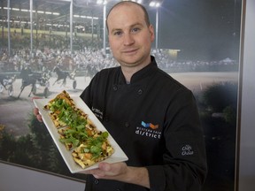 Top of the Fair executive chef Neil Mackay shows off veggie flatbread, which is one of the many delights that will be available at the Western Fair. The flatbread has been topped with bittersweet Thornloe brie cheese. It also features mint arugula, as well as an assortment of grilled plums. (DEREK RUTTAN, The London Free Press)