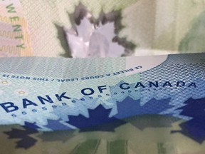 Canadian bank notes are seen Wednesday September 6, 2017 in Ottawa.The Bank of Canada is once again raising its benchmark interest rate as it sees the economy's powerful performance pointing to broader, more self-sustaining growth. THE CANADIAN PRESS/Adrian