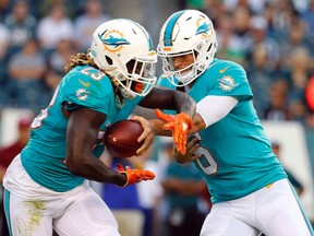 In this Aug. 24, 2017, file photo, Miami Dolphins quarterback Jay Cutler hands the ball off to running back Jay Ajayi during a preseason game against the Philadelphia Eagles. (AP Photo/Winslow Townson, File)