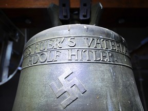 In this May 19, 2017 file photo a church bell with the inscription 'Everything for the fatherland Adolf Hitler' and a swastika is pictured in the town church in Herxheim am Berg, Germany. (Uwe Anspach/dpa via AP, file)