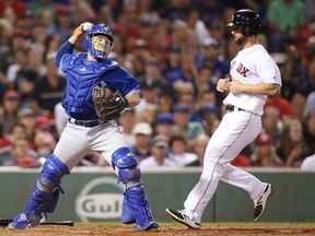 Blue Jays' Raffy Lopez forces the out at home plate as Sam Travis of the the Boston Red Sox runs in the second inning on Monday.