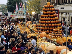 This undated photo provided by TourismOhio shows a display of pumpkins shaped like a tree amid crowds at the Circleville Pumpkin Show in Circleville, Ohio. The small town of just 12,000 people south of Columbus attracts tens of thousands of visitors to its free pumpkin festival each October, this year scheduled for Oct. 18-21. (TourismOhio via AP)