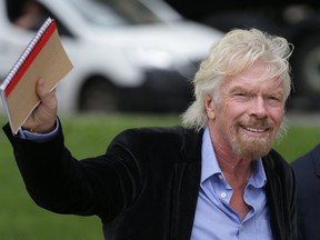 British entrepreneur Richard Branson waves as he walks by the Houses of Parliament in central London on June 28, 2016. (AFP/GETTY IMAGES)
