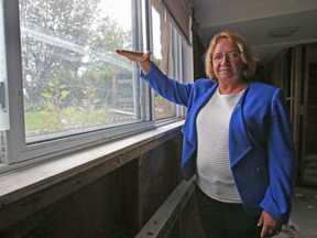 Gatineau Coun. Sylvie Goneau shows waterline on window that marks how high flood waters were in her home. She has been told she must demolish her house because it is within a flood zone. JEAN LEVAC