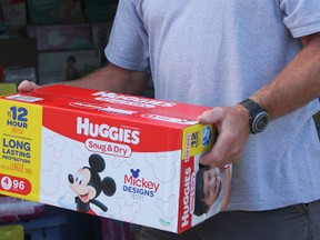 Retired Sarnia firefighter Kyle McKelivie loads a trailer with donated diapers that volunteers are driving to Texas to aid flood victims. (NEIL BOWEN/Sarnia Observer)