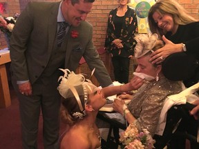 Angela Madonna wipes tears away from her mom, Jacqueline. The older woman, who had a stroke two weeks ago, had just watched her daughter get married. A nurse helps keep Jacqueline steady in her wheelchair. Supplied photo