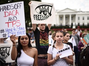 Protesters hold signs in support of DACA, outside of the White House in Washington, Tuesday, Sept. 5, 2017. (Eric Baradat/Getty Images)