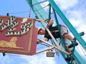 Pieter Le Cante wires up the lights Wednesday for the sign on Pharaoh?s Fury ride at the Western Fair in London. The fair opens Friday with more than 50 rides, fair food, more than 800 animals, plus entertainment and attractions. (MIKE HENSEN, The London Free Press)