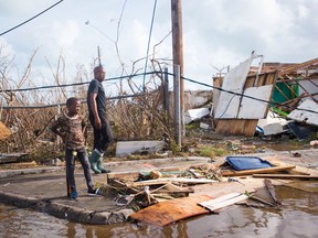 People look at damage on September 7, 2017, in Marigot, near the Bay of Nettle, on the island of Saint Martin after the passage of Hurricane Irma. (LIONEL CHAMOISEAU/Getty Images)