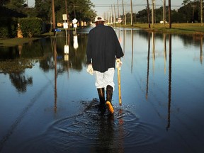 Paul Morris checks on neighbors homes in a flooded district of Orange as Texas slowly moves toward recovery from the devastation of Hurricane Harvey on September 7, 2017 in Orange, Texas.  (Photo by Spencer Platt/Getty Images)