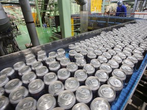 Cans of beer roll off an assembly line. (AP Photo/Koji Sasahara)
