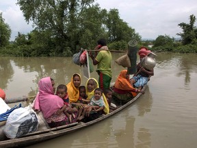 Rohingya Muslim refugees arrive on a small boat after crossing the Myanmar Bangladesh border on September 7, 2017 in Whaikhyang, Bangladesh. (Dan Kitwood/Getty Images)