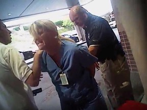 In this July 26, 2017, frame grab from video taken from a police body camera and provided by attorney Karra Porter, nurse Alex Wubbels is arrested by a Salt Lake City police officer at University Hospital in Salt Lake City. (Salt Lake City Police Department/Courtesy of Karra Porter via AP)