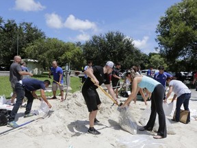 City of Miami volunteers help residents fill free sandbags Thursday, Sept. 7, 2017, in Miami, as residents prepare for Hurricane Irma. (AP Photo/Alan Diaz)