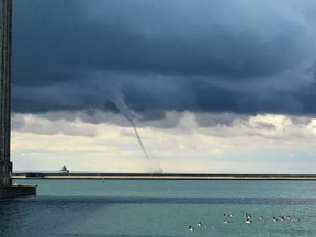 A waterspout makes its way east on Lake Erie toward the foghorn Thursday September 7, 2017 in Port Colborne, ON. Waterspouts and funnel clouds over the lake were reported in Port Colborne and Wainfleet Thursday morning. More are expected to form Friday. Dave Johnson/Postmedia