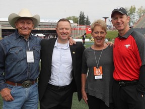 Calgary Stampeders head coach Dave Dickenson, right, and Edmonton Eskimos GM Brock Sunderland meet up with legendary Montana high school football coach Jack Johnson, left, and his wife, Rosann, ahead of the 2017 Labour Day Classic at McMahon Stadium on Monday, Sept. 4, 2017.