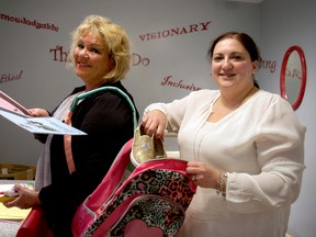 Shelley Stewart, a program supervisor at Rotholme Women’s and Family Shelter (left), and Mariana Karatzas, a case worker, prepare a backpack with school supplies for a local family. Mission Services of London is still collecting much-needed backpacks and school supplies for families staying at the Rotholme shelter. (CHRIS MONTANINI, Londoner)