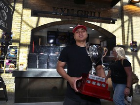 Kyu Grill co-owner Peter Truong displays the trophy for ManyFest Food Truck Wars People's Choice Winner in front of its restaurant space at The Forks in Winnipeg on Wed., Sept. 6, 2017. Kevin King/Winnipeg Sun/Postmedia Network
