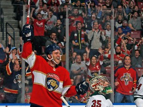 Jonathan Huberdeau raises his stick to celebrate the goal by Mark Pysyk of the Florida Panthers as Goaltender Darcy Kuemper of the Minnesota Wild looks up at the scoreboard during first period action at the BB&T Center on March 10, 2017. (Joel Auerbach/Getty Images)