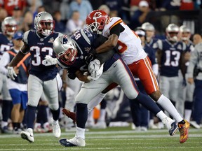 New England Patriots tight end Rob Gronkowski (87) carries Kansas City Chiefs safety Eric Berry (29) on his back after catching a pass during the first half of an NFL football game, Thursday, Sept. 7, 2017, in Foxborough, Mass. (AP Photo/Steven Senne)