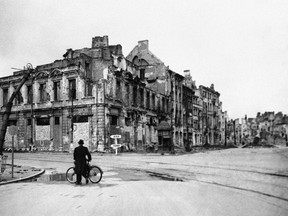 In this Oct. 1, 1945 file photo, a solitary cyclist contemplates a panorama of total destruction in Warsaw, the capital of Poland, months after World War II. (AP Photo/Files)