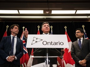 Minister of Finance, Charles Sousa, centre, Attorney General, Yasir Naqvi, right, and Minister of Health and Long-Term Care, Eric Hoskins speak during a press conference where they detailed Ontario's solution for recreational marijuana sales, in Toronto on Friday, September 8, 2017. THE CANADIAN PRESS/Christopher Katsarov