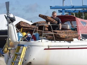 A Canada Border Services Agency officer inspects the sailboat Quesera at East River Marine in Hubbards, N.S., on Friday, Sept. 8, 2017. Approximately 273 kilograms of suspected cocaine were found on the vessel and two men were arrested. (Andrew Vaughan/The Canadian Press)