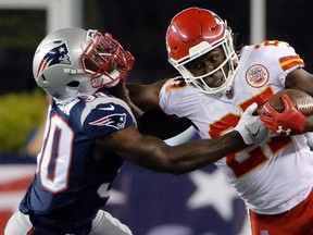 Kansas City Chiefs running back Kareem Hunt (27) gives a stiff arm to New England Patriots safety Duron Harmon Thursday, Sept. 7, 2017, in Foxborough, Mass. (AP Photo/Steven Senne)