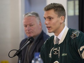 Alec Regula speaks at a press conference to announce his signing with the London Knights at Budweiser Gardens in London, Ont. on Friday September 8, 2017. Beside him is the team's president, owner and head coach Dale Hunter. (DEREK RUTTAN, The London Free Press)