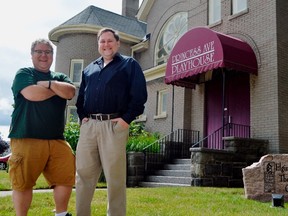 Sam Shoebottom, left, and John Allen stand in front of the historic Princess Avenue Playhouse, a church converted to a stage for the Elgin Theatre Guild in 1987. The production company turns 50 this year, and showrunners are looking for ways to keep it alive at a time when most entertainment has gone digital. (Louis Pin/The Times-Journal)