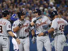 Nick Castellanos (second from right) of the Detroit Tigers is congratulated by teammates Ian Kinsler, Jeimer Candelario and Dixon Machado after hitting a grand slam against the Blue Jays at Rogers Centre on September 8, 2017 in Toronto. (Tom Szczerbowski/Getty Images)