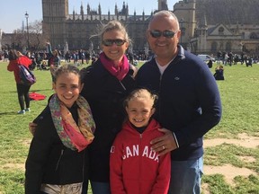 Former Edmonton resident Cristy Cunningham, left, her husband Robert Gomez, right, pose for a photo with their two children. Cunningham has lived in Miami for 13 years and is preparing to ride out hurricane Irma.